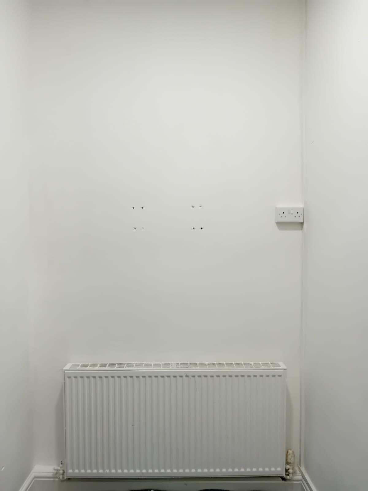 After: wall above the radiator smooth and painted white