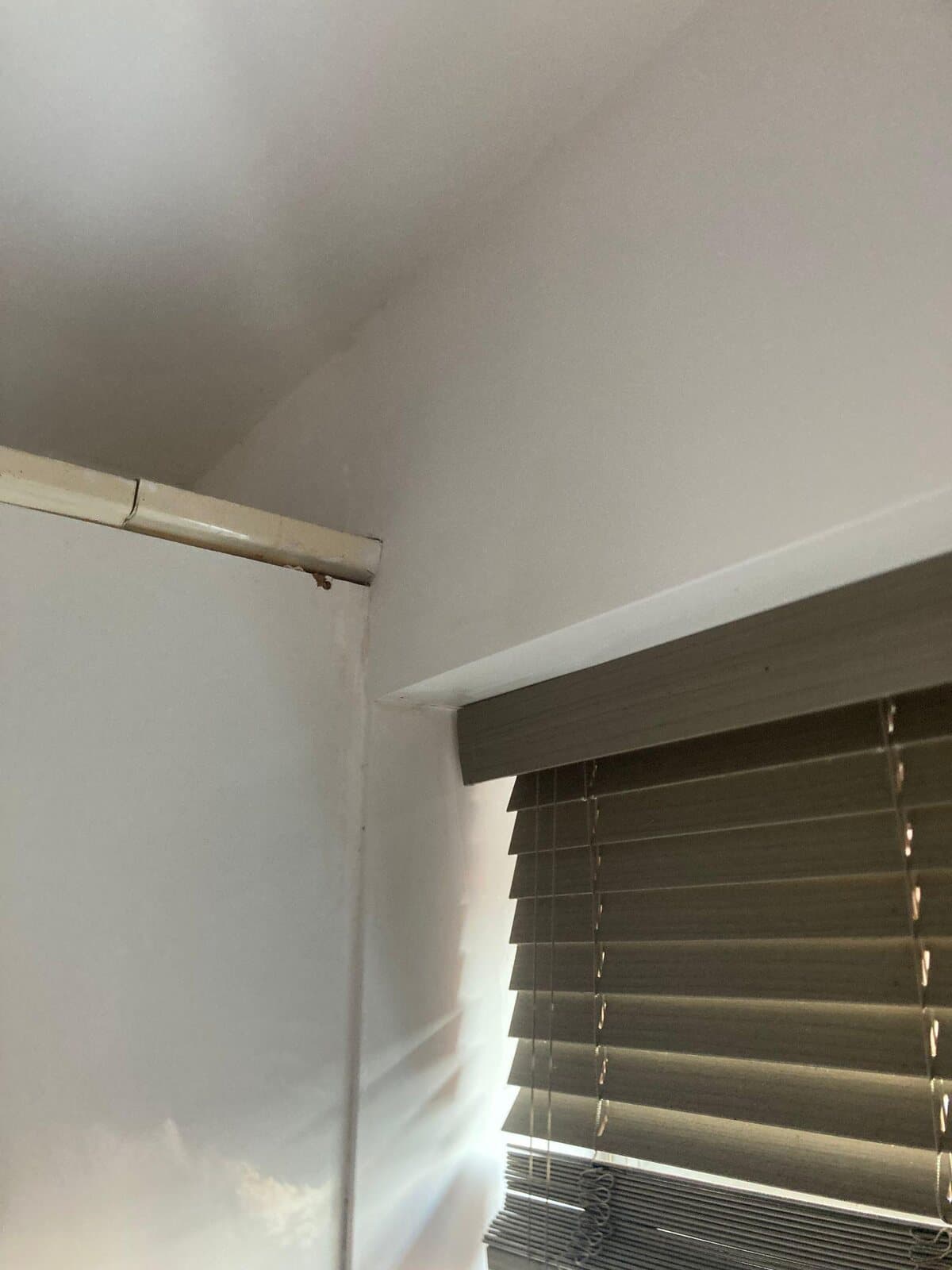 After: the corner sealed and painted clean white