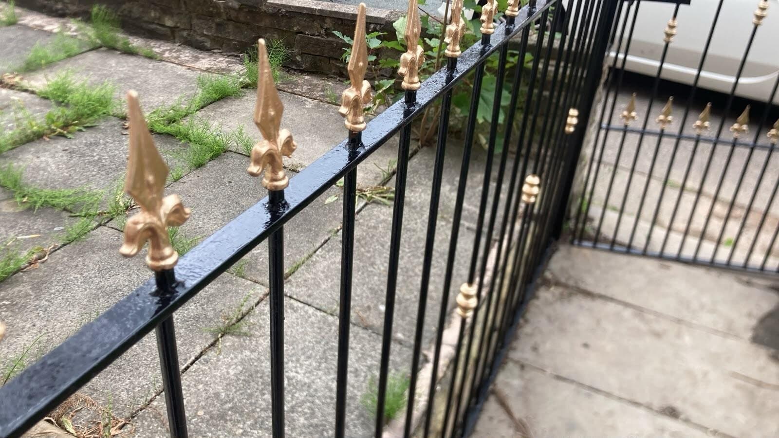 After: railings repainted gloss black with gold tips