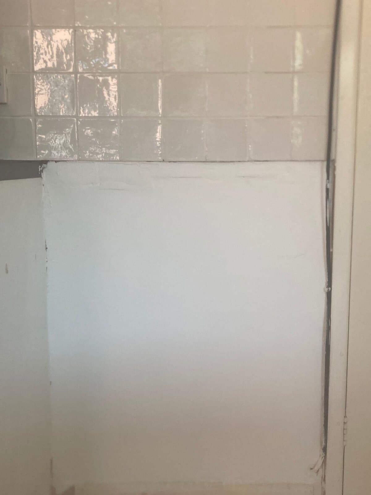 After: wall under the tiles made good and painted white
