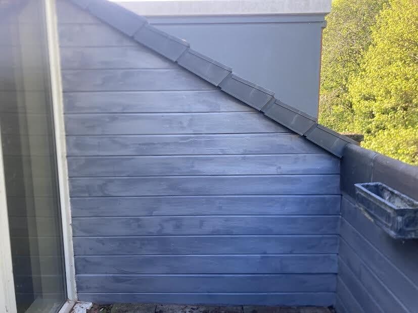 After: balcony cladding painted grey